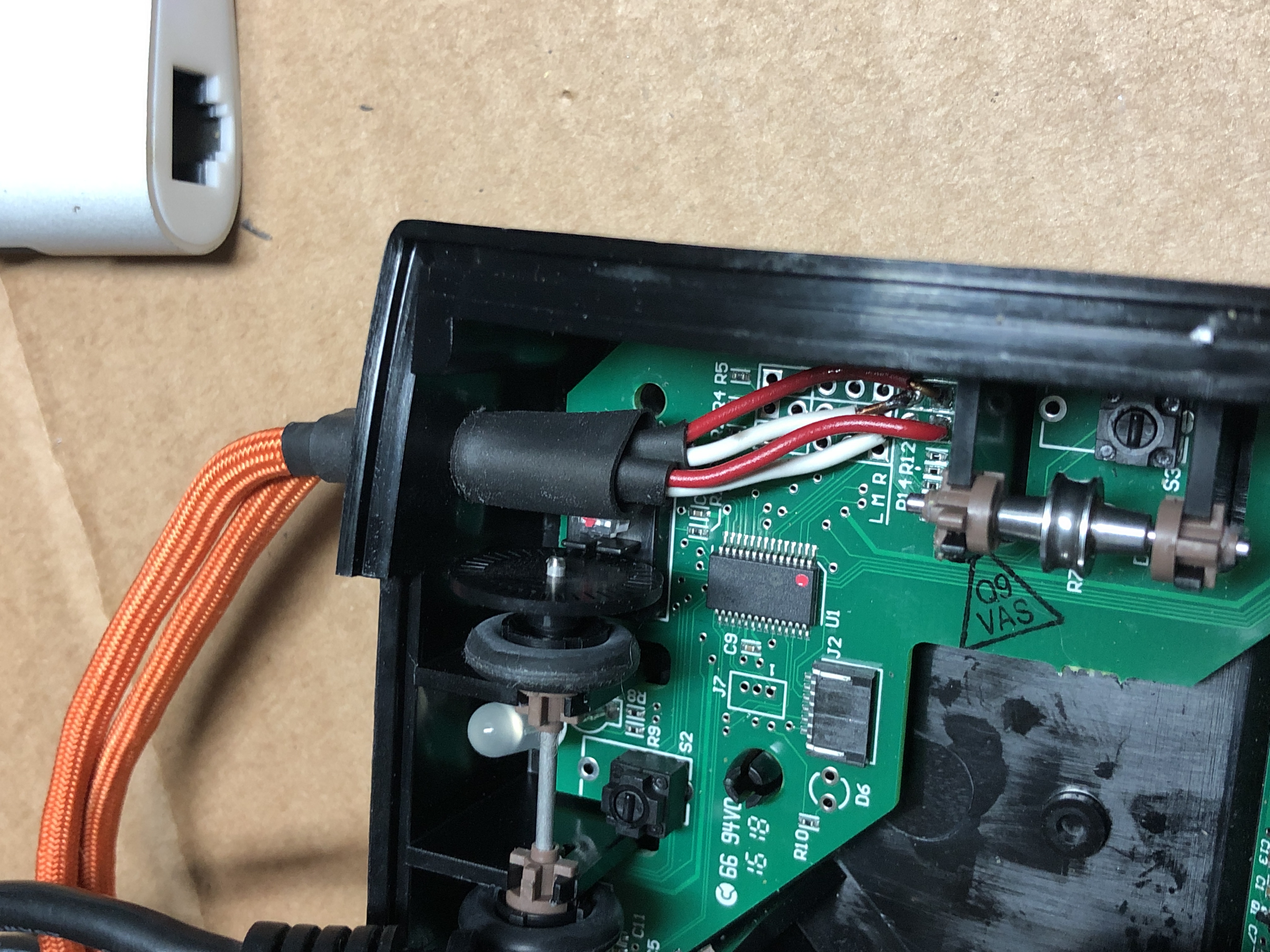 Wires attached to the PCB run out a hole in the back of the enclosure