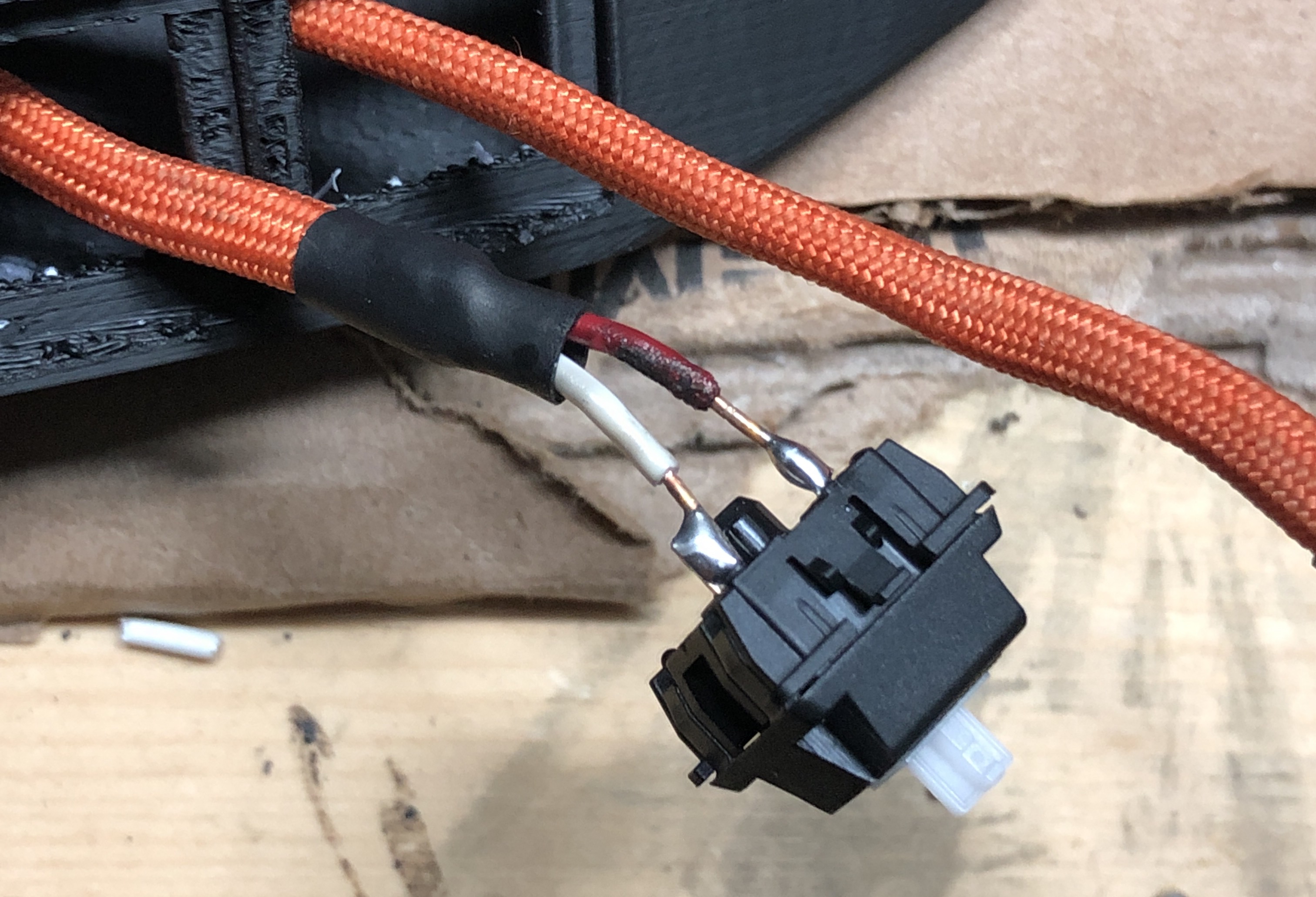 Wires soldered to the tips of a keyboard switch